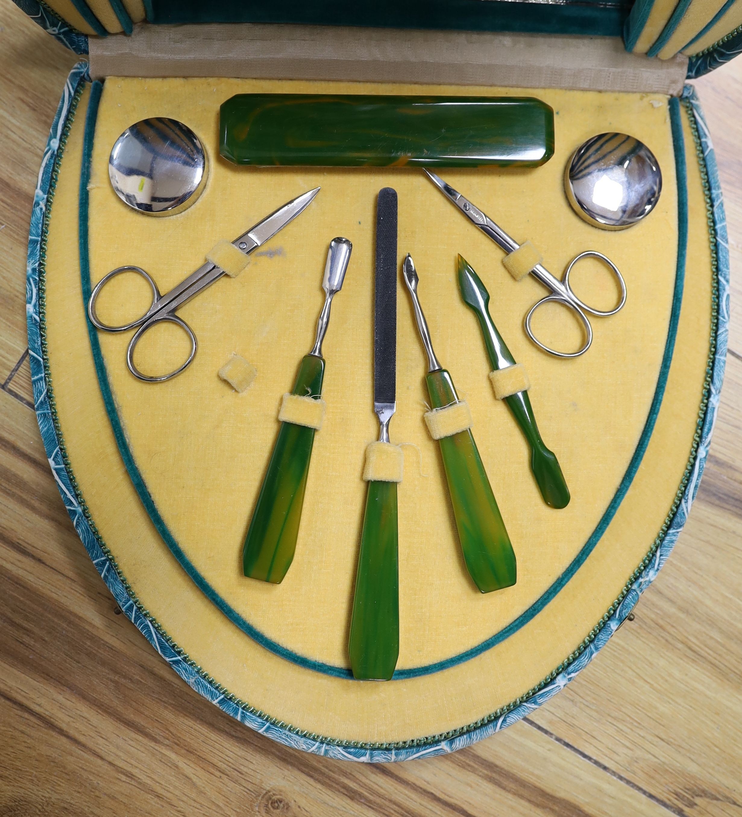 A cased manicure set, and ivory and silver mounted handle and an Egyptian ivory letter opener, 24cm